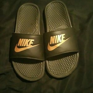 Gold Nike slides